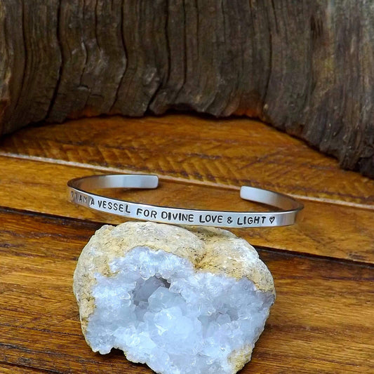 Right side view of a sterling silver affirmation cuff bracelet hand-stamped with "I AM A VESSEL FOR DIVINE LOVE & LIGHT".