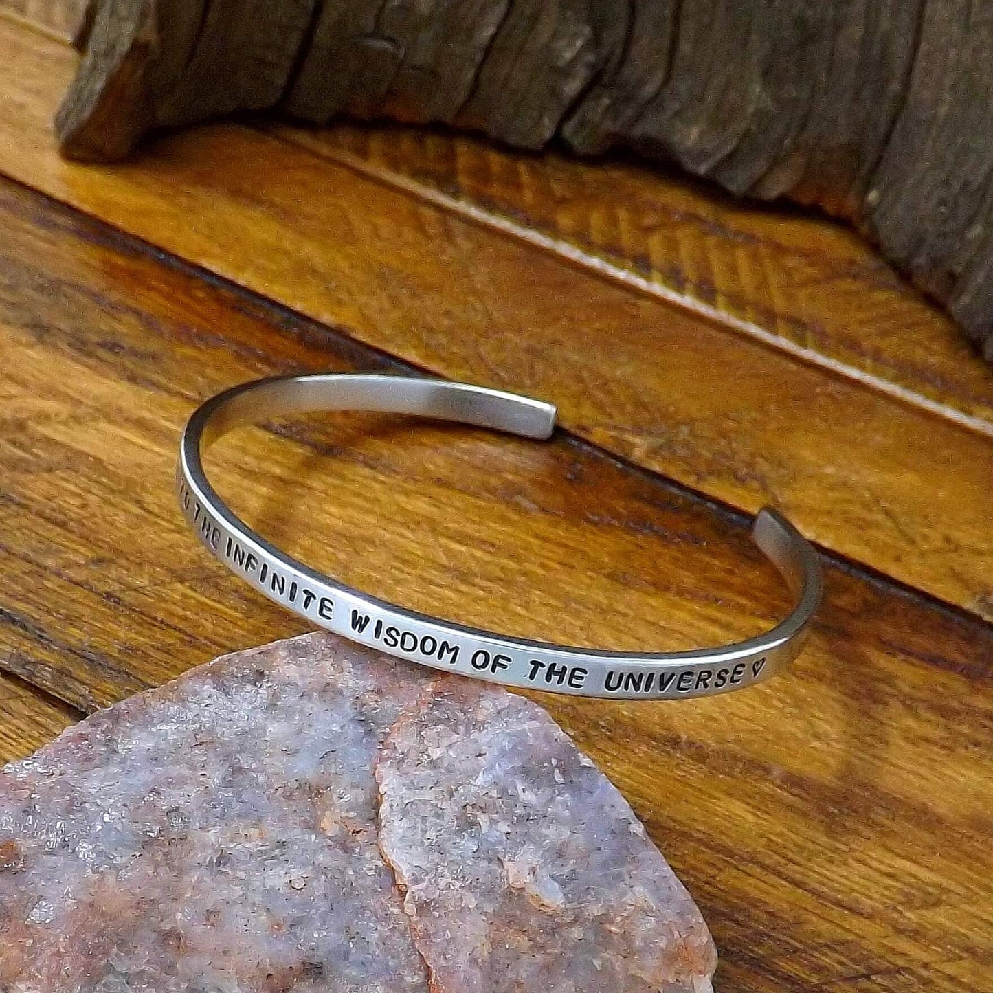 Right view of a sterling silver affirmation cuff bracelet hand-stamped with "I AM CONNECTED TO THE INFINITE WISDOM OF THE UNIVERSE".