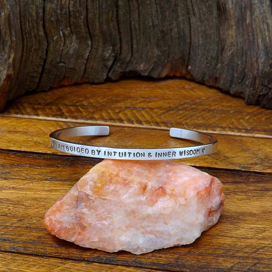 Right side view of a sterling silver affirmation cuff bracelet hand-stamped with "I Am Guided by Intuition & Inner Wisdom".
