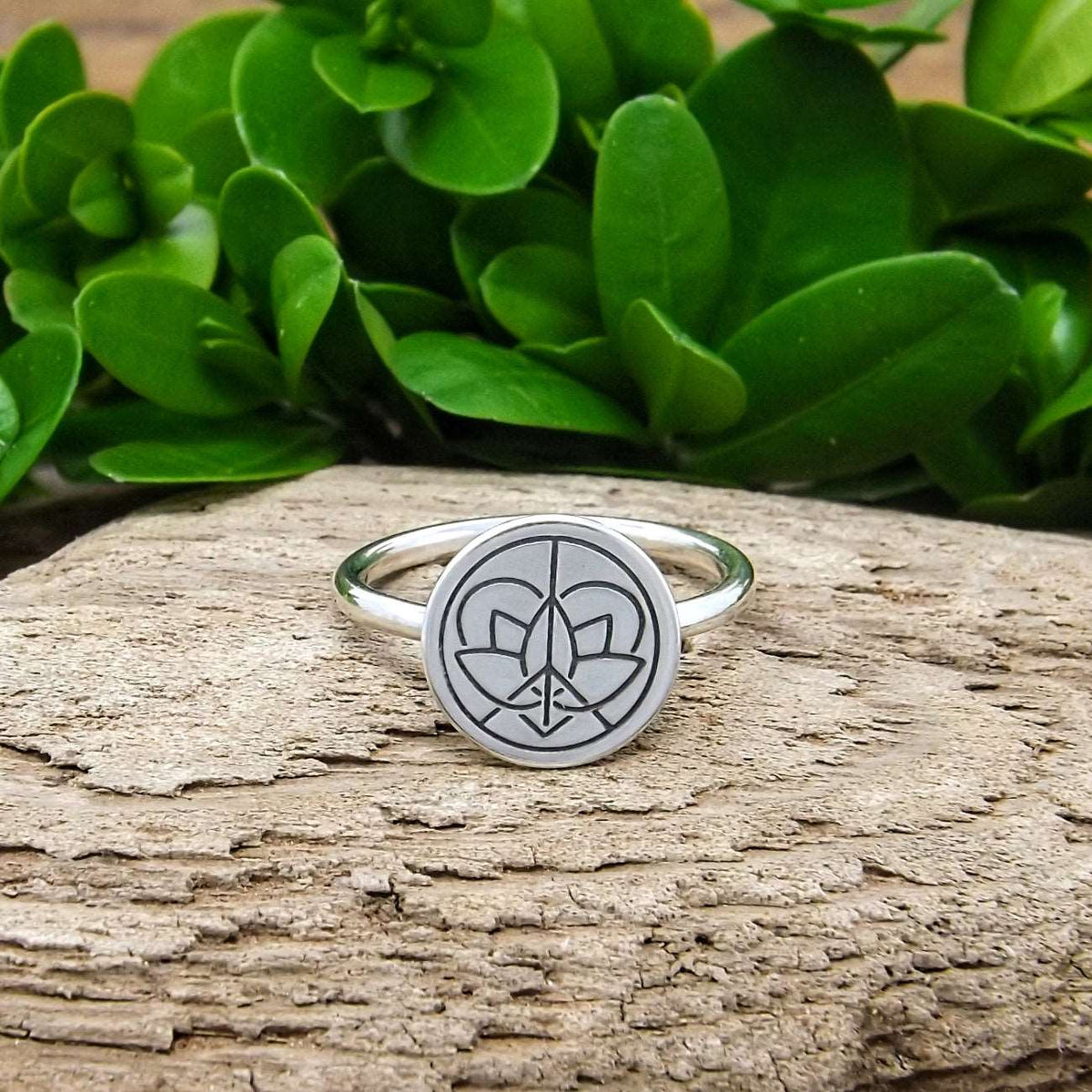 Front view of sterling silver classic band ring with large Jenn's Zen Creations hand-stamped logo.