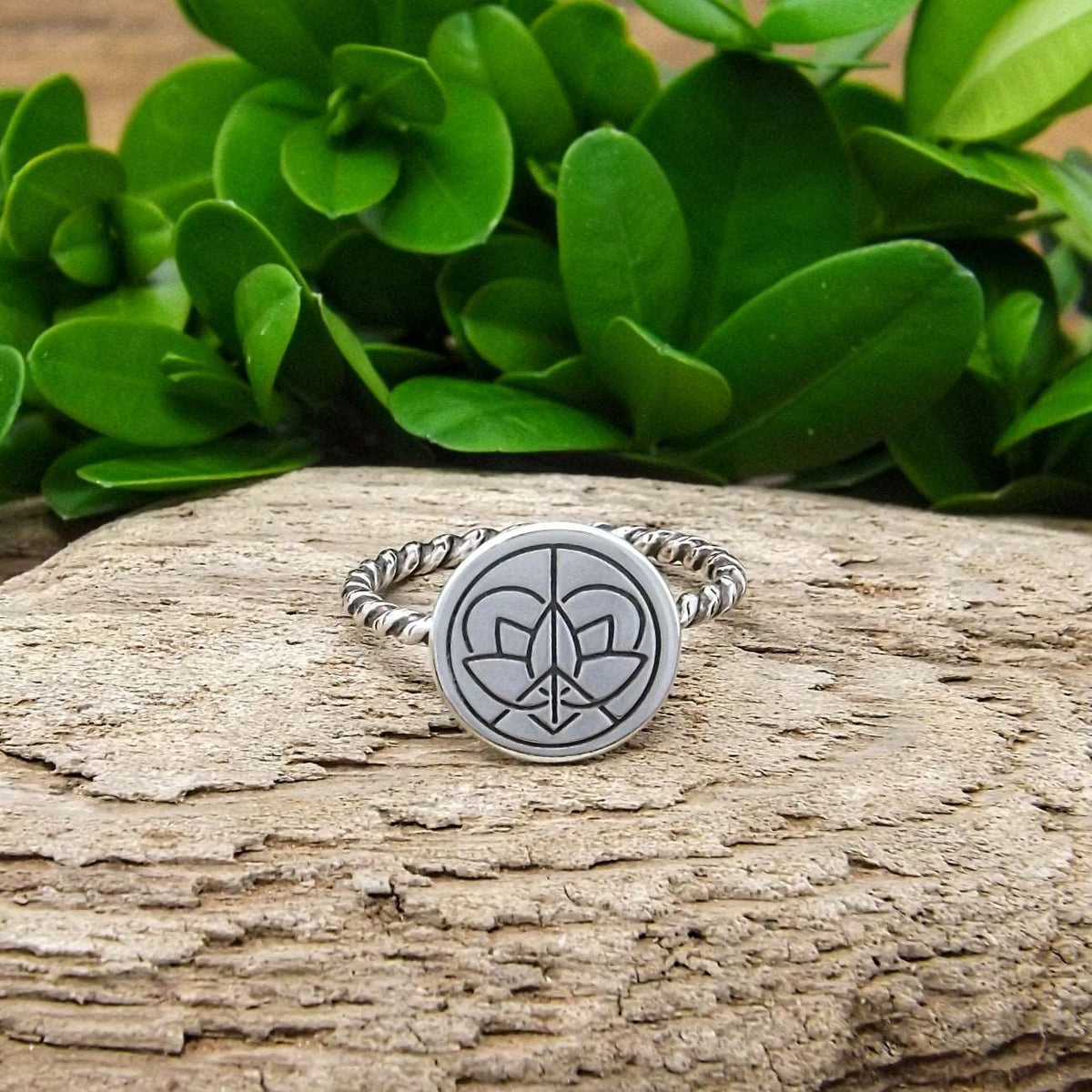 Front view of a sterling silver twist wire band ring with large Jenn's Zen Creations hand-stamped logo.
