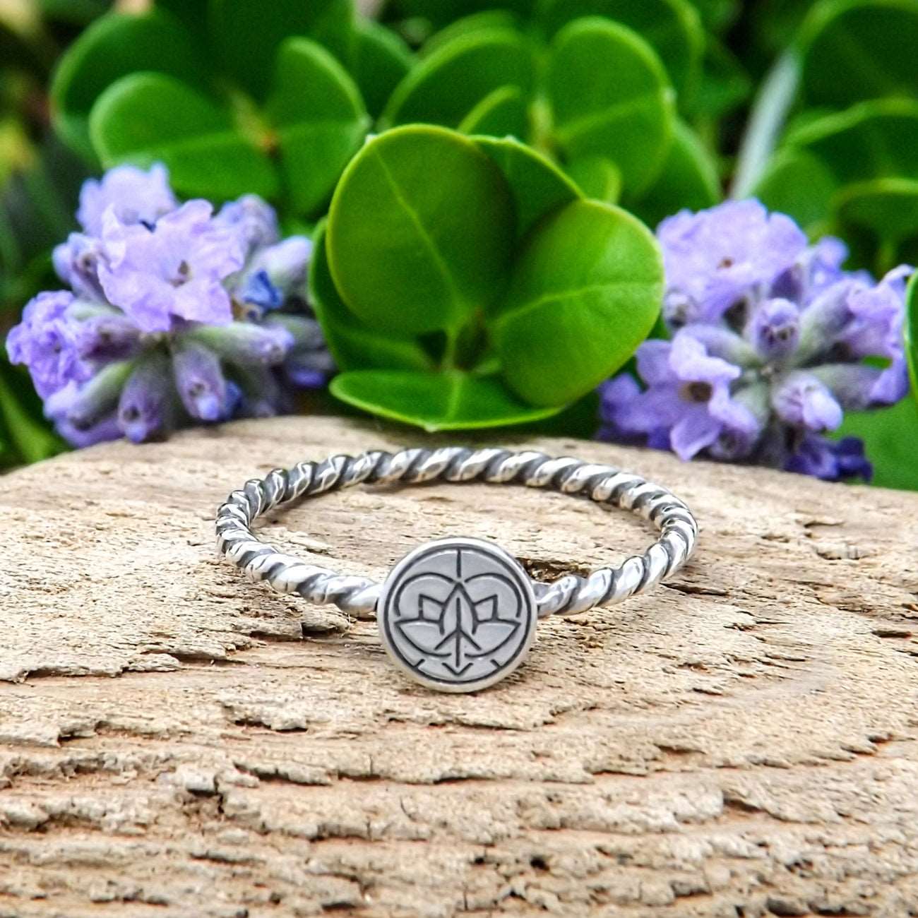 Front view of a sterling silver ring hand-stamped with Jenn's Zen Creations small logo.