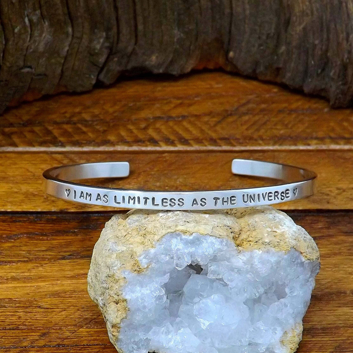 Front view of a sterling silver affirmation cuff bracelet hand-stamped with "I AM AS LIMITLESS AS THE UNIVERSE".