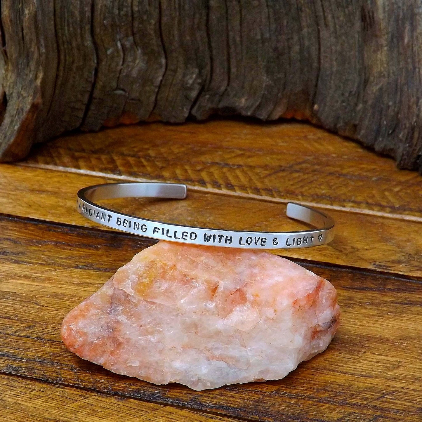 Right side view of a sterling silver affirmation cuff bracelet hand-stamped with "I AM A RADIANT BEING FILLED WITH LOVE & LIGHT".