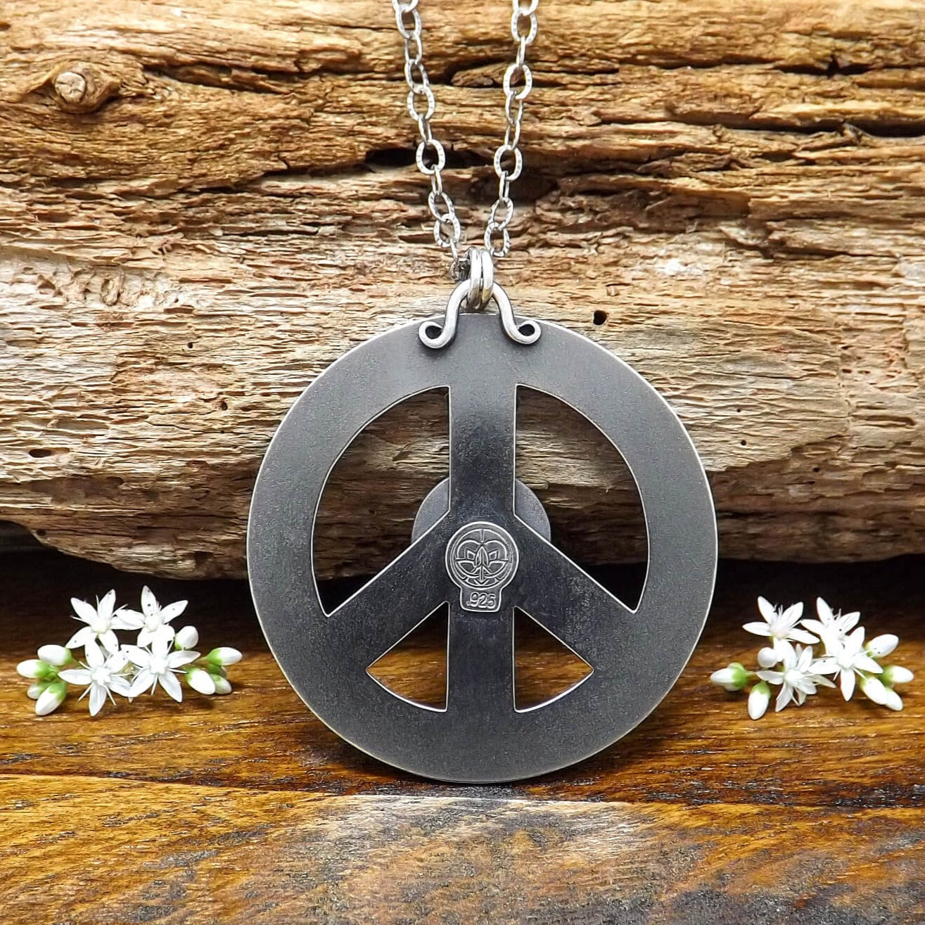 Back view of sterling silver peace sign necklace with makers mark.
