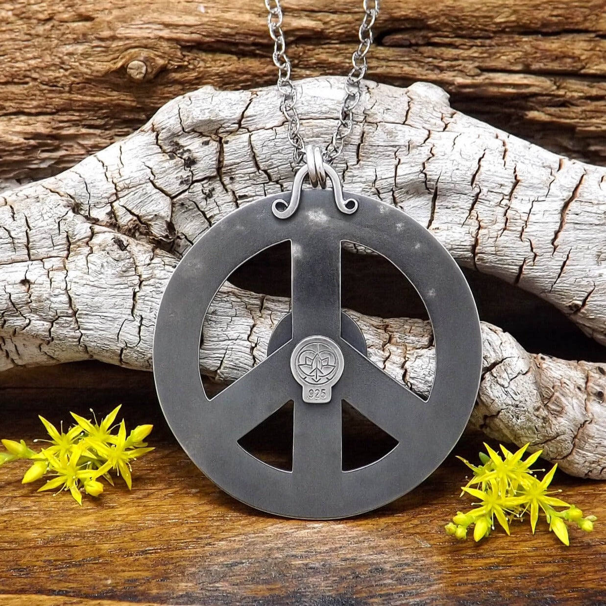 Back view of a sterling silver peace sign necklace with .925 makers mark.