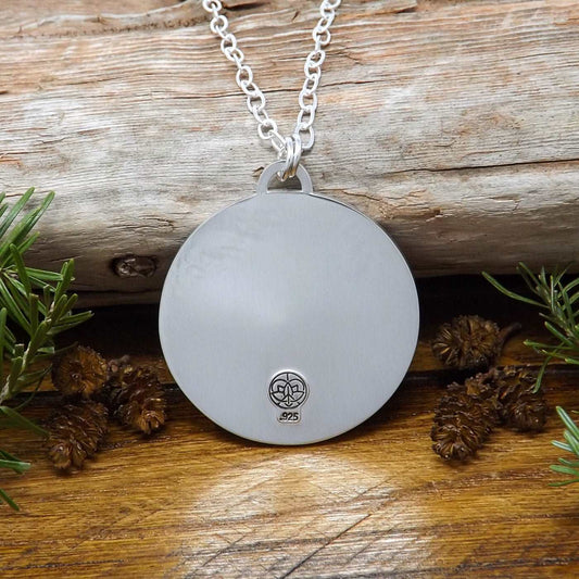 Back view of a sterling silver starry night mountain necklace with makers mark stamp.