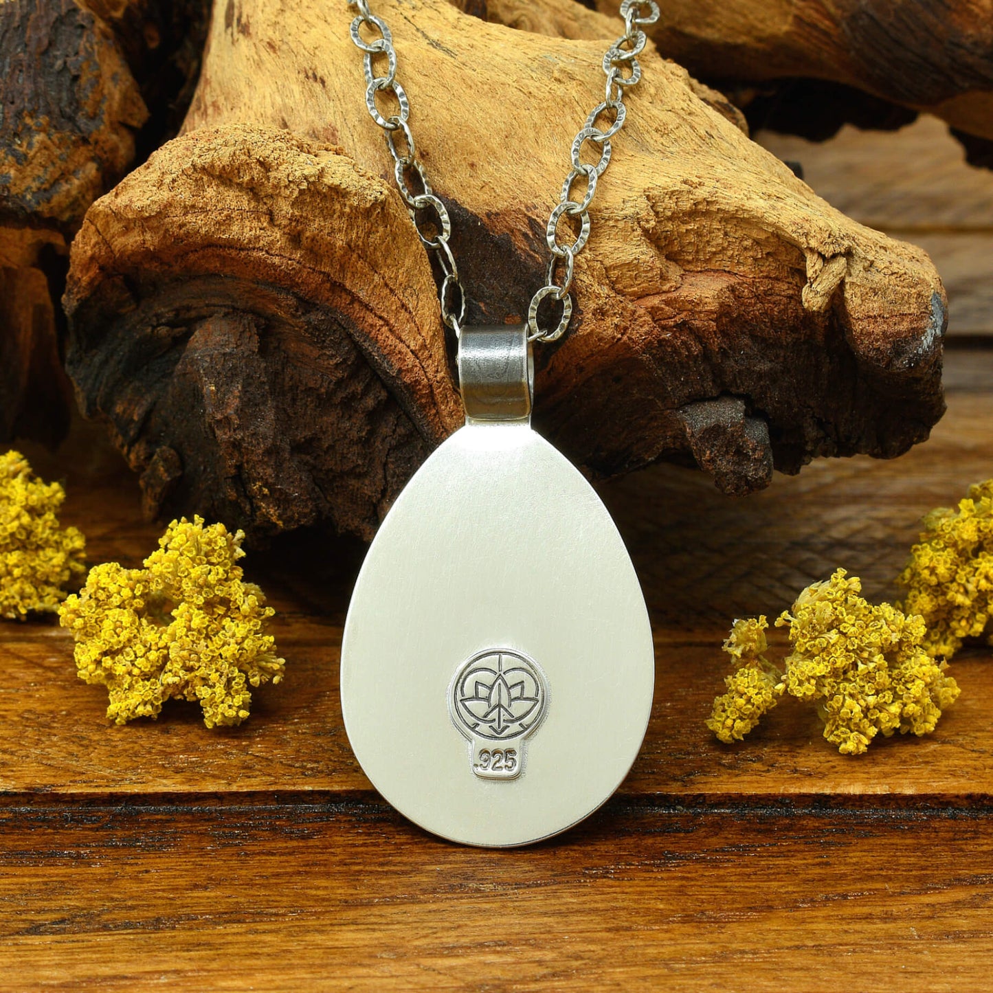 Back of sterling silver cherry blossom and crescent moon necklace with .925 makers mark.