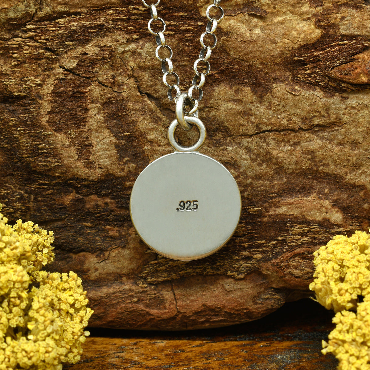 Back view of a sterling silver sunburst necklace with hand-stamped .925 hallmark.