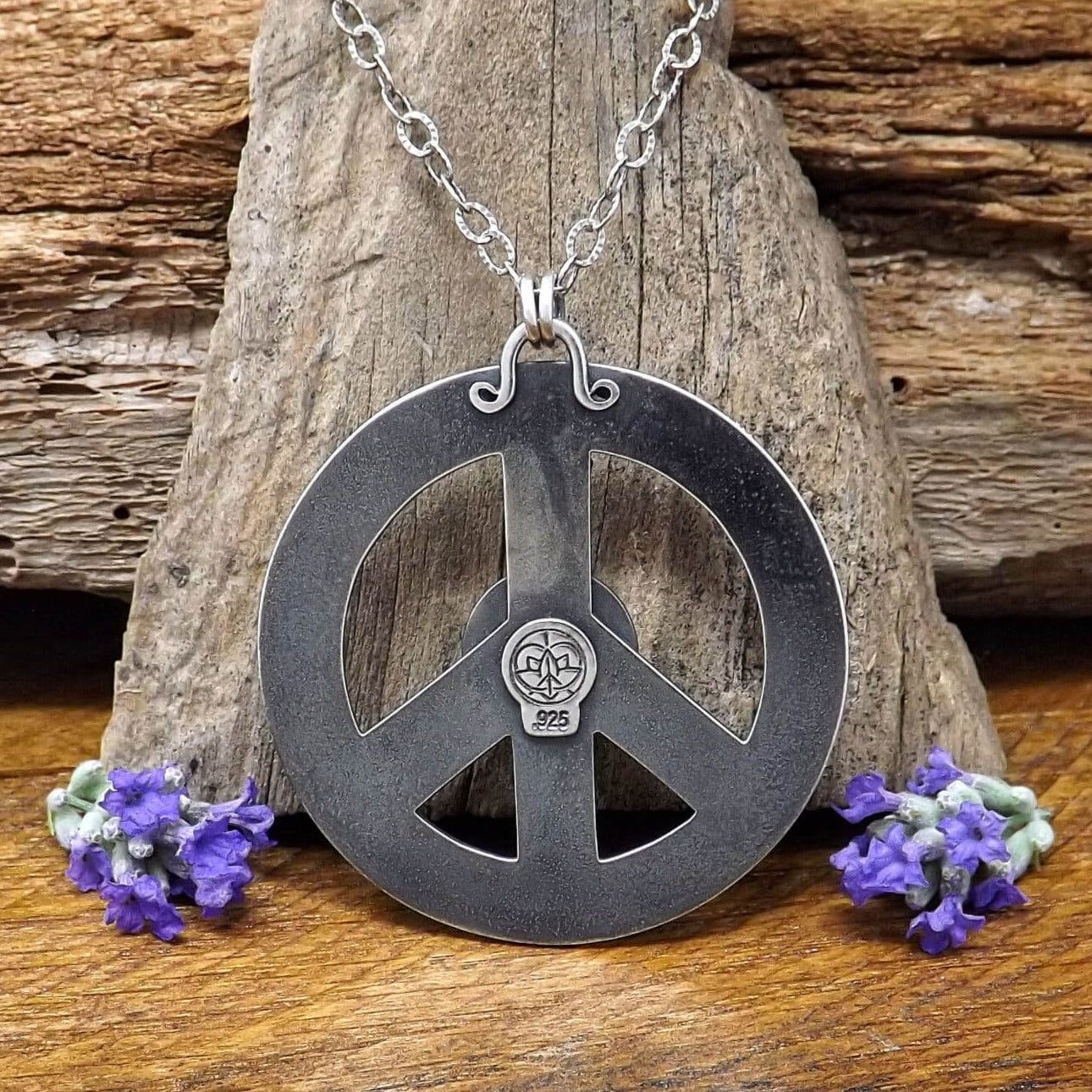 Back of sterling silver peace sign necklace with makers mark