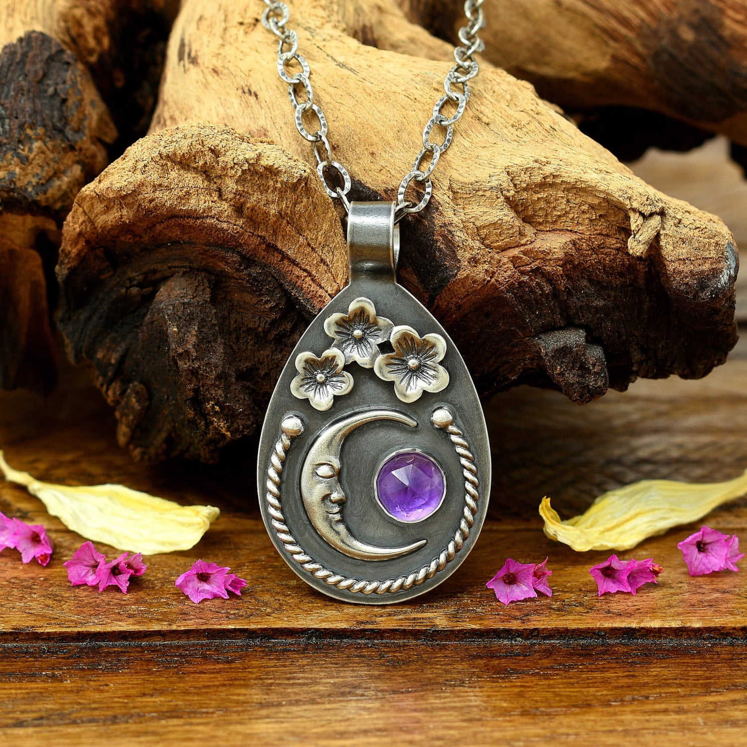 Front view of sterling silver cherry blossom and crescent moon necklace with a rose cut faceted amethyst gemstone.