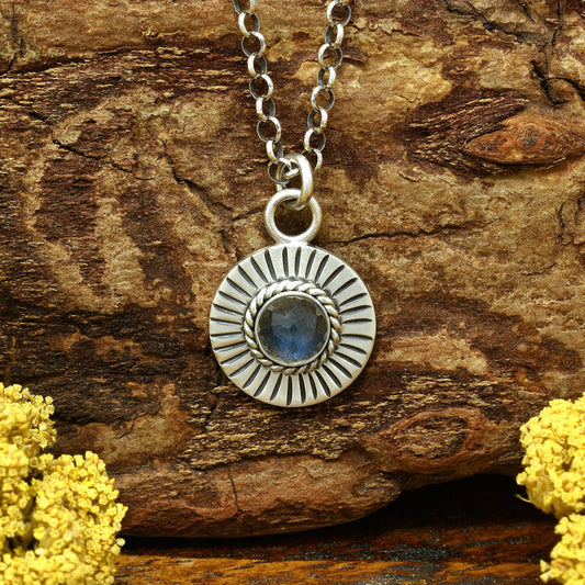 Front view of a sterling silver sunburst necklace with a rose cut faceted labradorite gemstone.