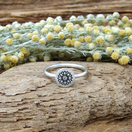 Front view of sterling silver stacking ring hand-stamped with sunflower design.